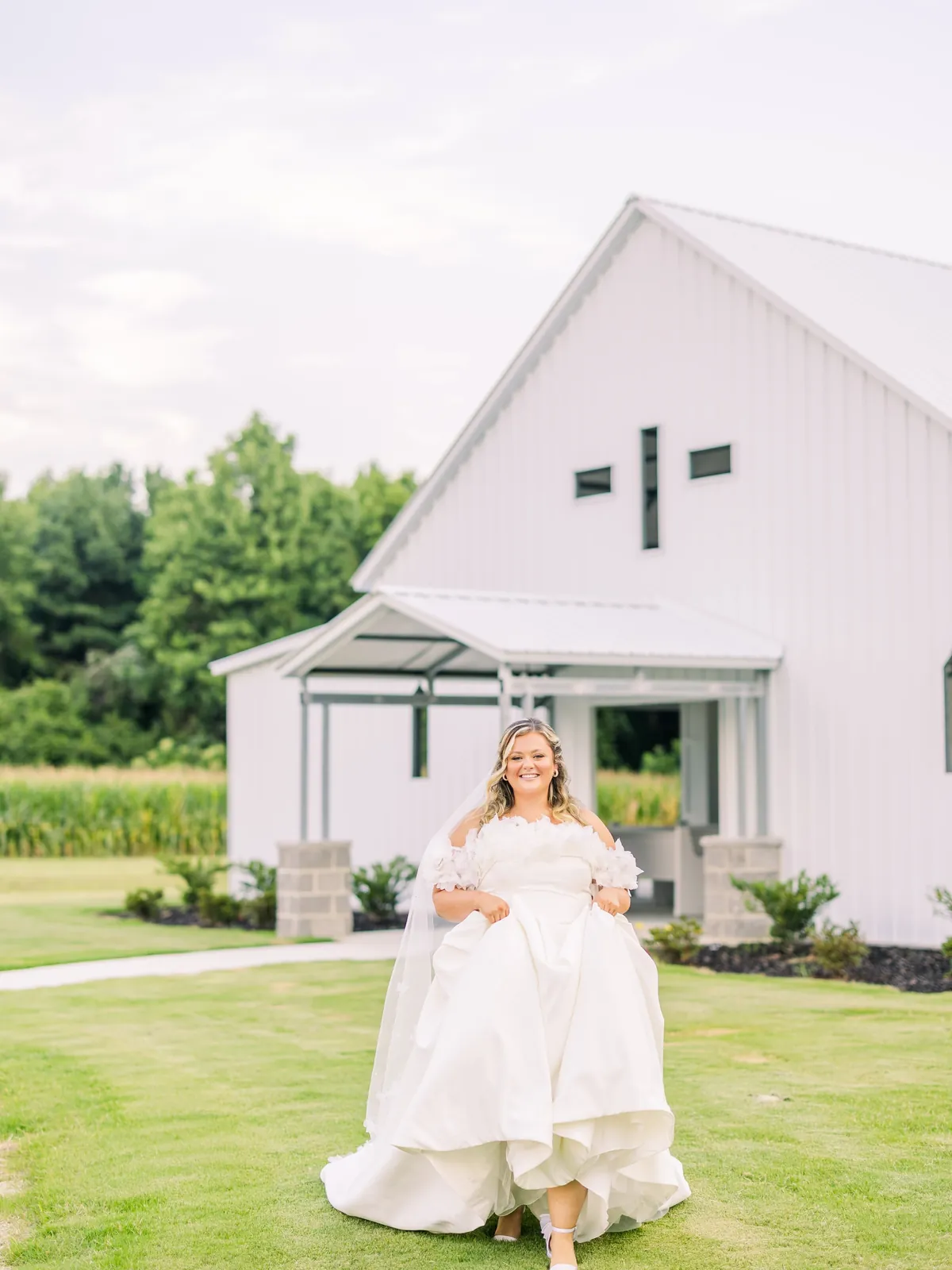 Bride in front of the white chapel at The Boldwood Grove